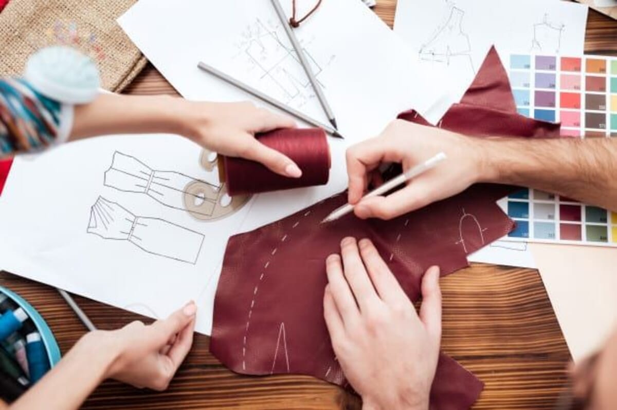 Garment production environment where both private-label and custom-manufactured pieces flow through the same factory floor before being routed to brand-specific finishing.