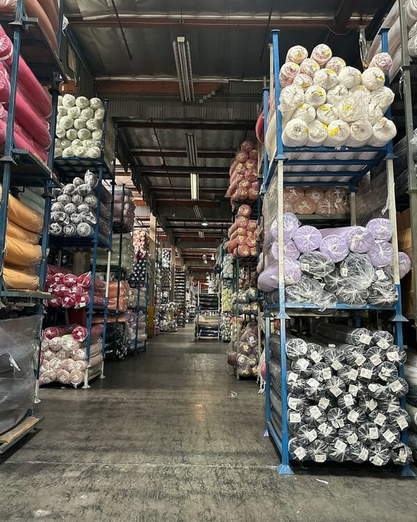 Racks of fabric rolls in a textile warehouse