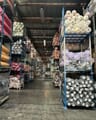 Racks of fabric rolls in a textile warehouse