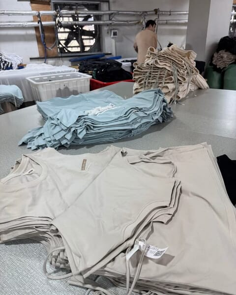 Folded T-shirts in two colors on a table