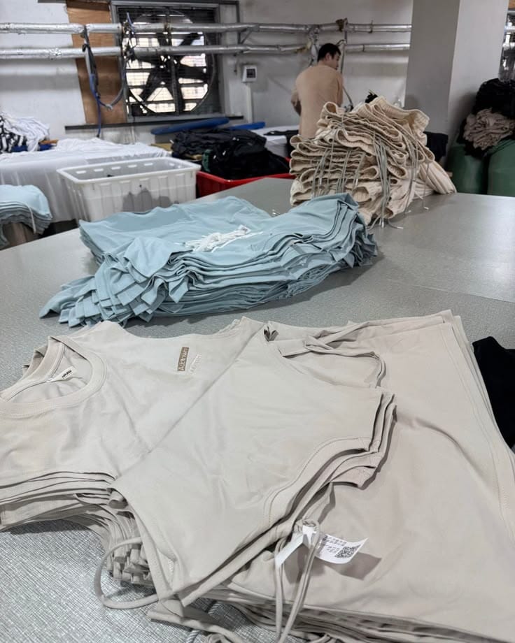 Folded T-shirts in two colors on a table