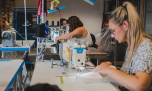 Operator sewing at a flatbed machine