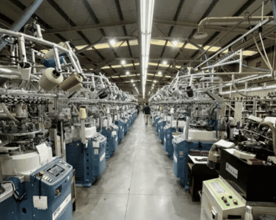 Rows of circular knitting machines on a knitting floor