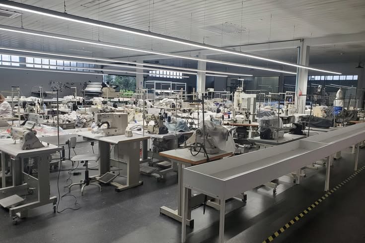 Empty sewing floor with machines and a conveyor