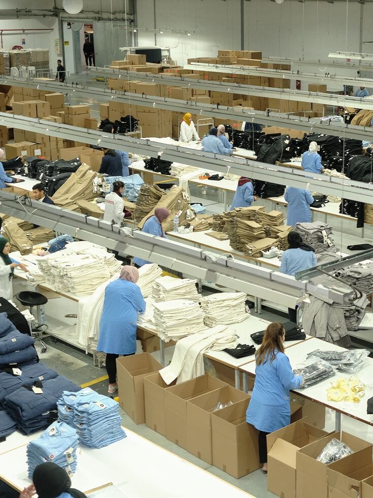 Factory floor with sewing lines and shipping boxes