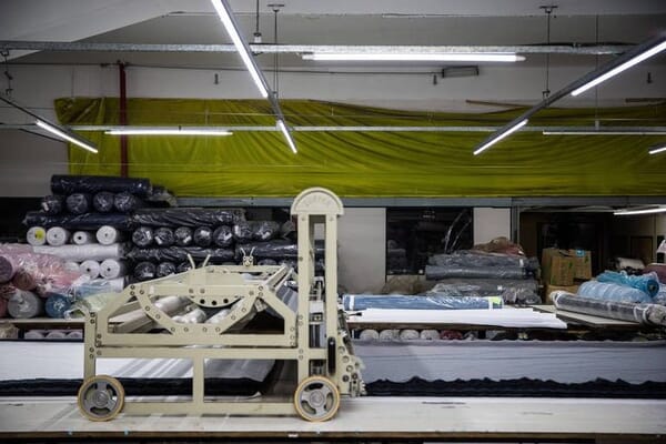Fabric spreading machine on a long cutting table