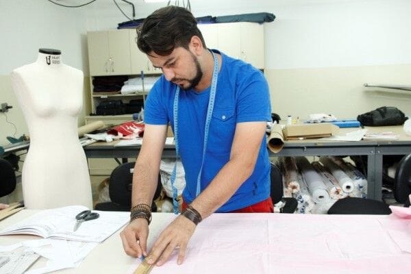 Pattern maker marking a pattern onto fabric