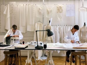 Sample makers fitting toiles on dress forms