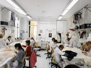 Sample makers at their tables in a bright atelier