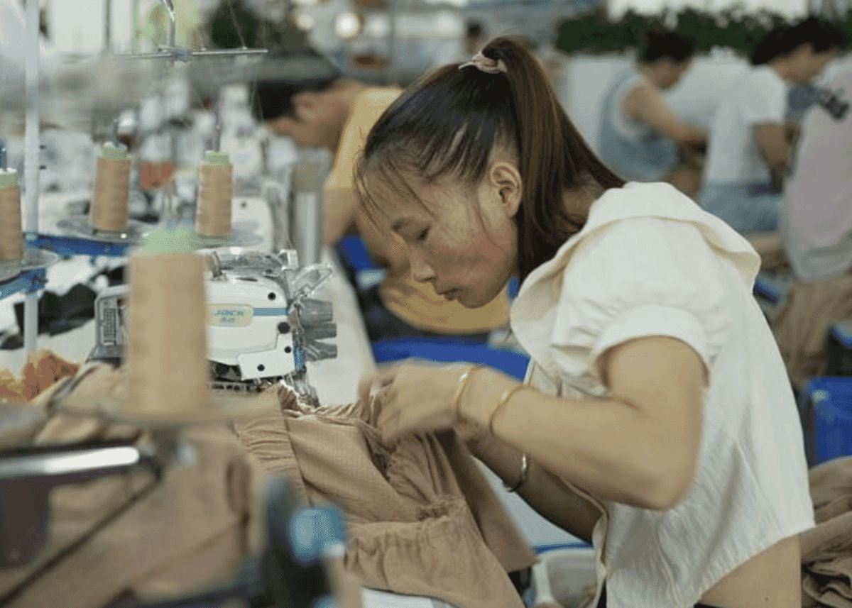 Garment factory production floor with sewing lines in operation