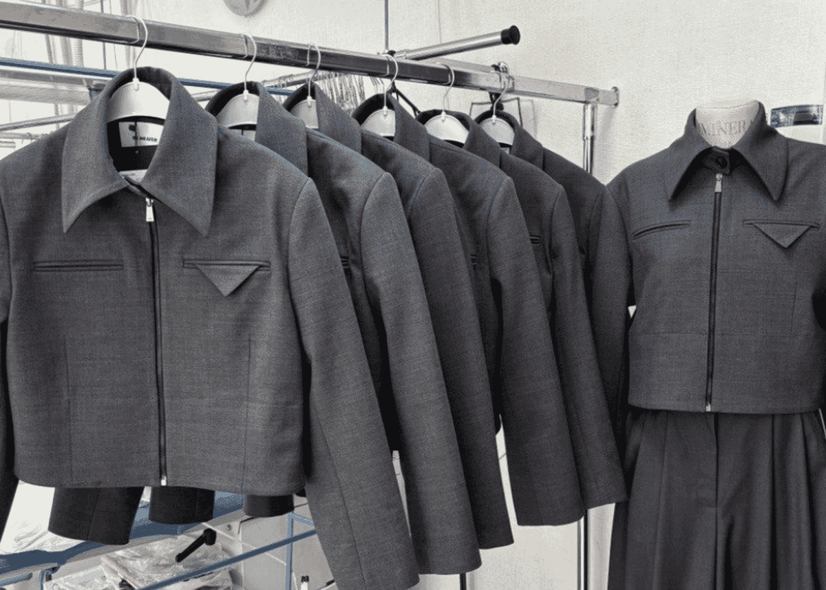 Grey cropped jackets on a rail beside a matching outfit on a mannequin