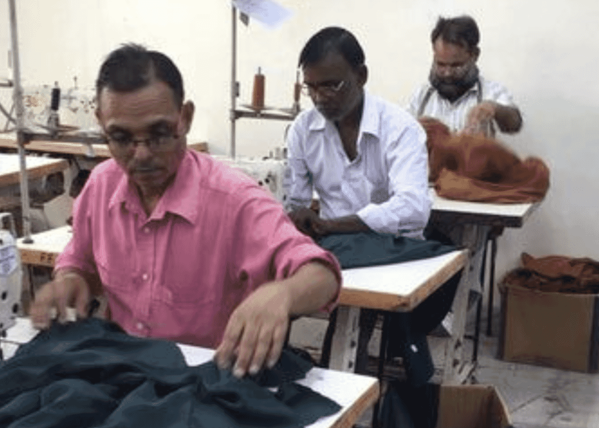 Cutting table with layered fabric and pattern marker in an Indian factory