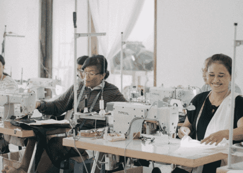 Two machinists sewing samples in a bright workroom