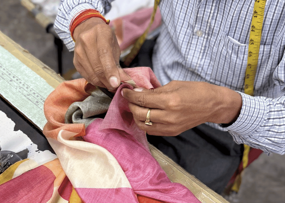 Stacked fabric rolls awaiting cutting in an Indian mill