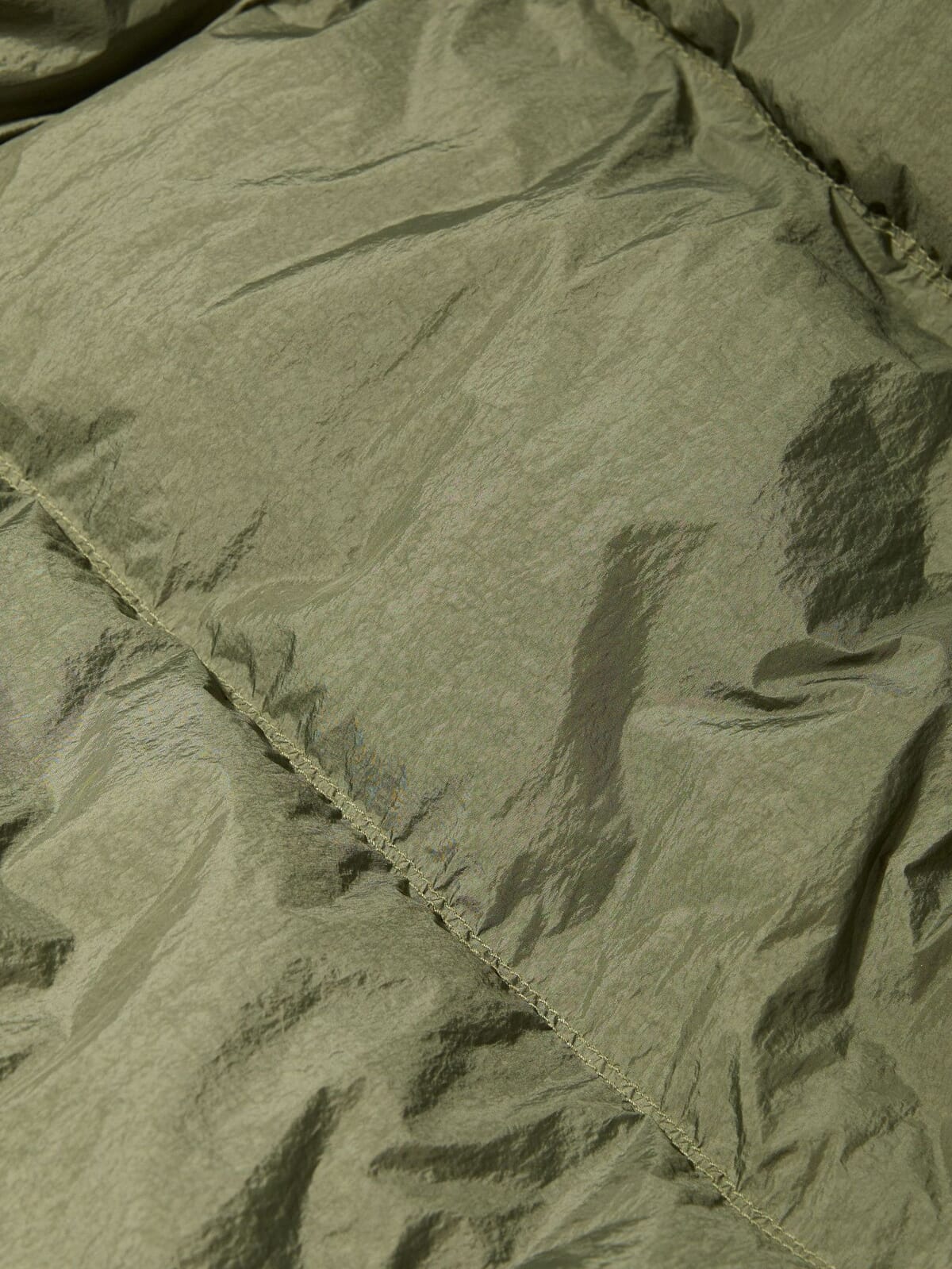 Olive crinkle nylon fabric with a stitched seam