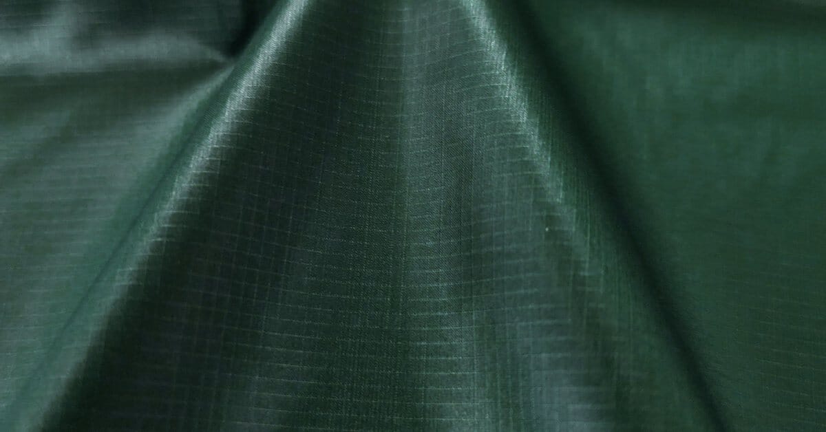 Technical performance fabric close-up showing the face and membrane