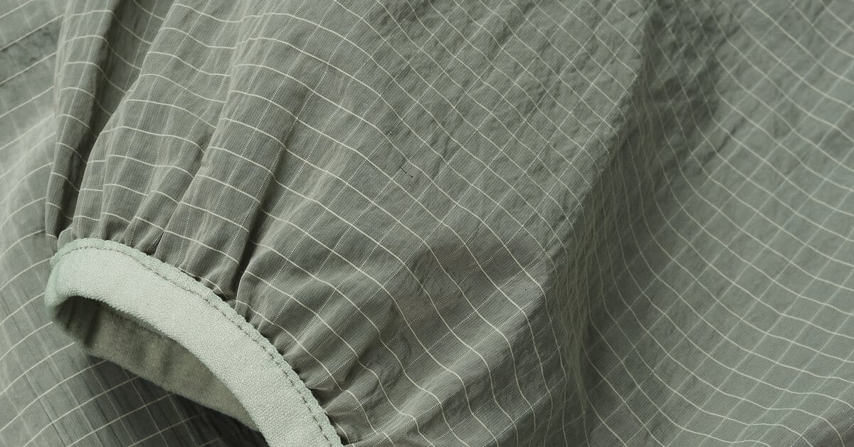 Technical performance fabric close-up showing the face and membrane