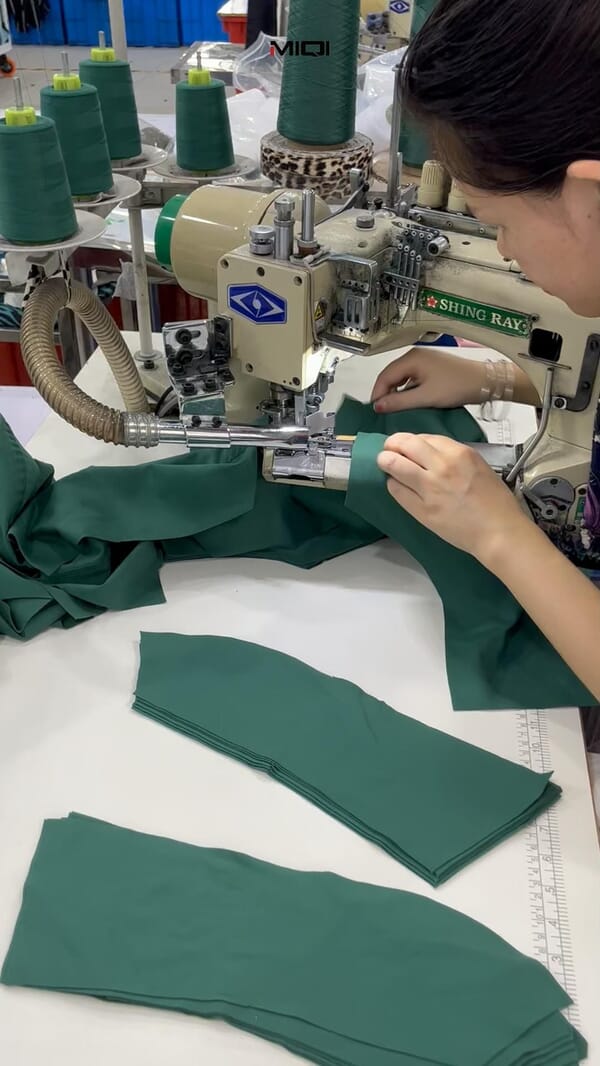 Operator flatlock sewing green activewear panels