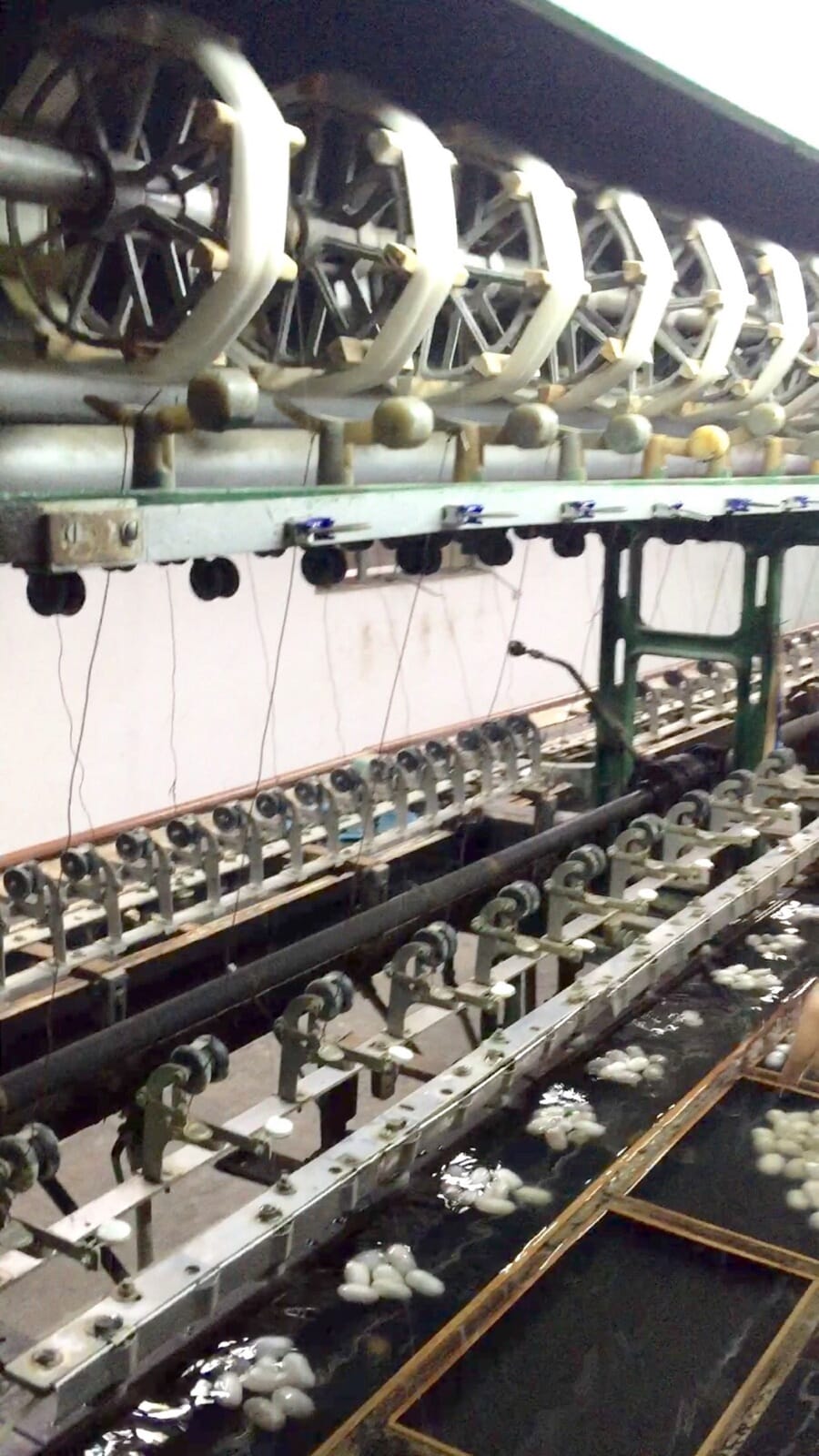Close view of spinning machinery winding yarn