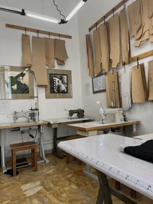 Card patterns hanging on the wall above a sample room cutting table