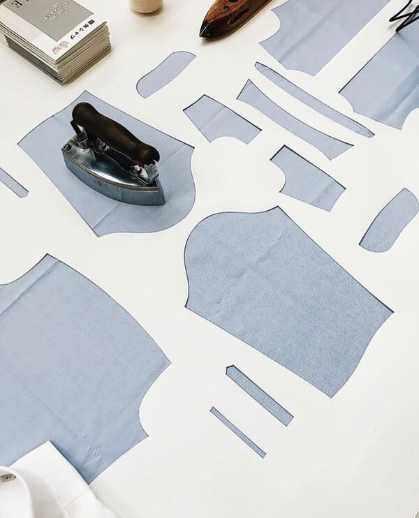 Cut pattern pieces laid out on a white table