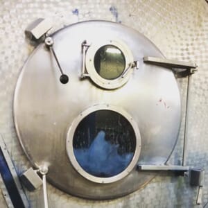 Denim visible through the door of an industrial washer
