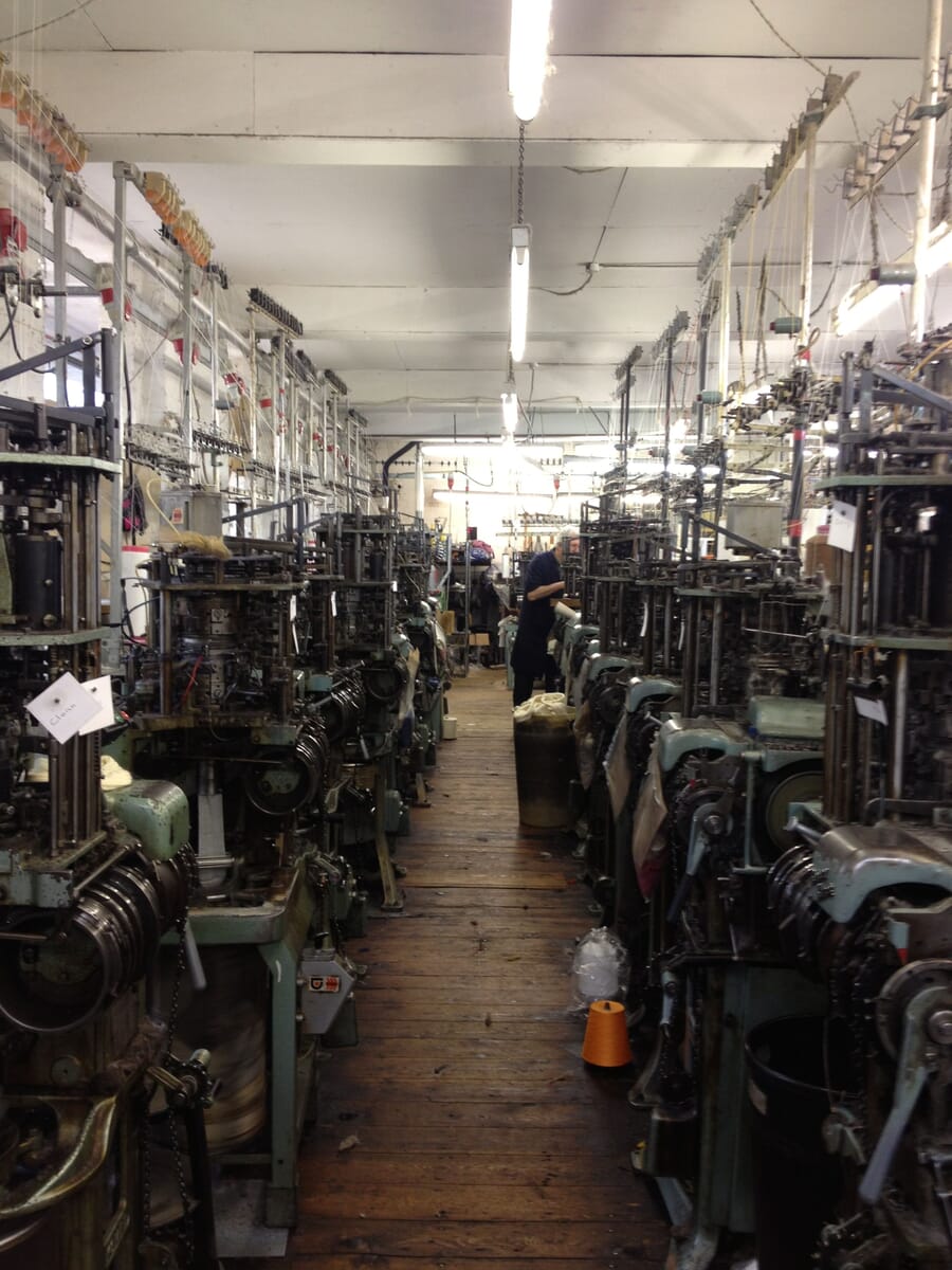 Narrow knitting room lined with sock machines