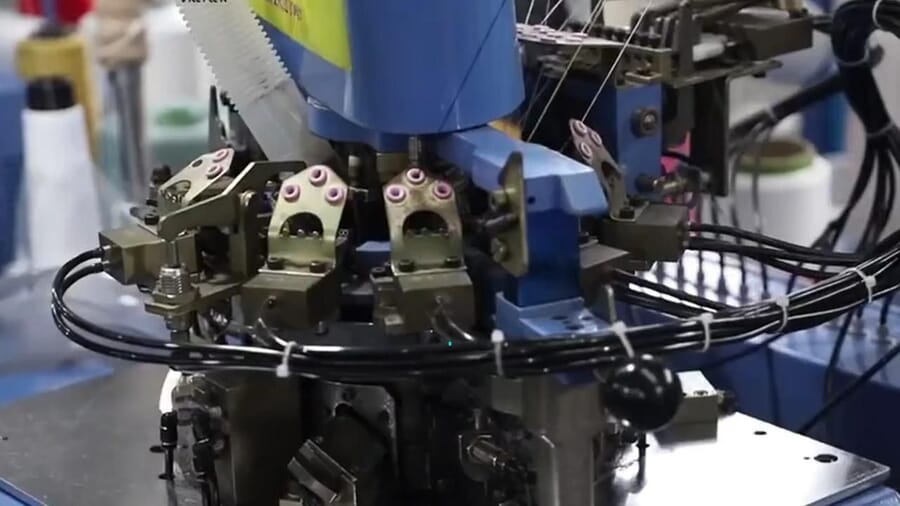 Close-up of the knitting head of a sock machine