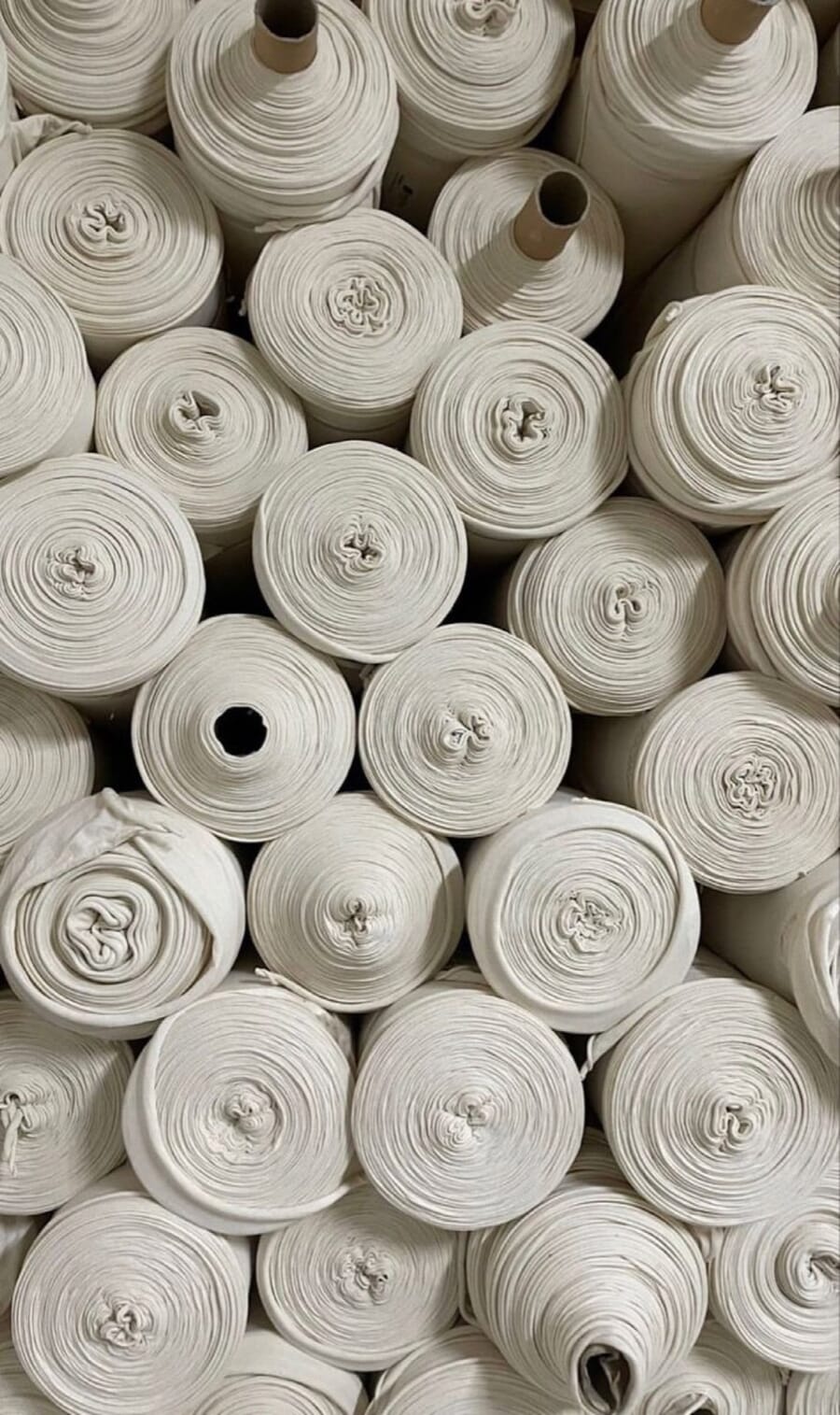 White yarn cones packed side by side