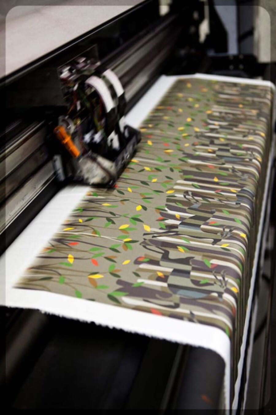 Print head of a digital fabric printer over a patterned print