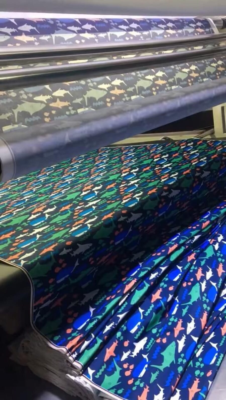 Brightly printed fabric coming off a wide fabric printer