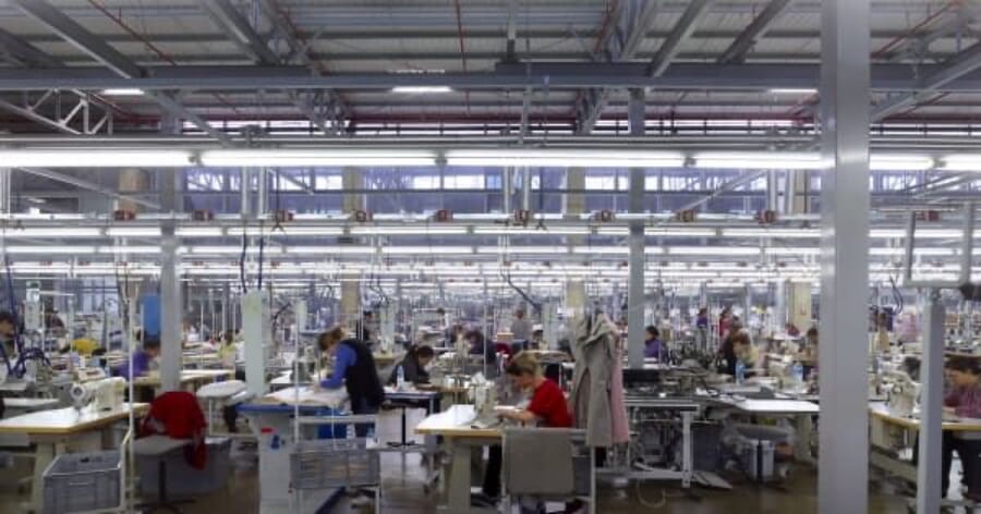 Wide sewing floor with long lines of operators at their machines