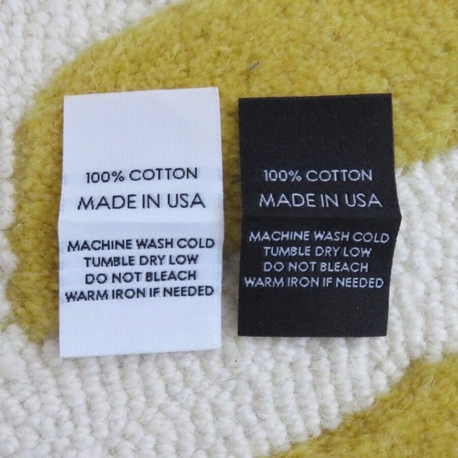 Two woven labels reading 100% cotton, Made in USA, with care instructions