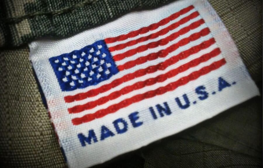 Woven US flag label reading Made in U.S.A. sewn into an olive garment