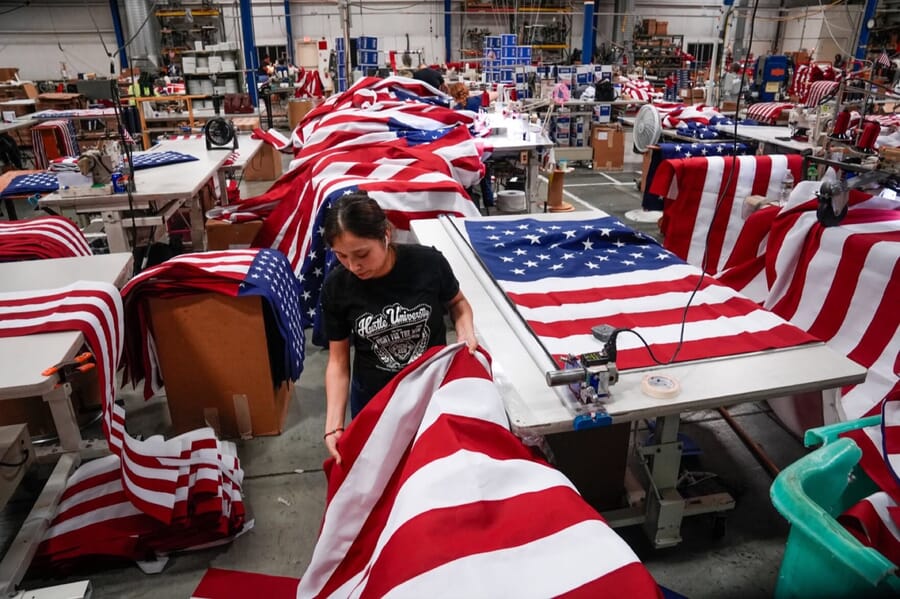 Sewing floor with US flags spread over the work tables