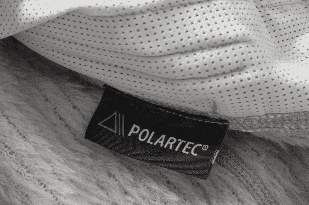 A technical outdoor mid-layer jacket made from licensed Polartec fleece construction.