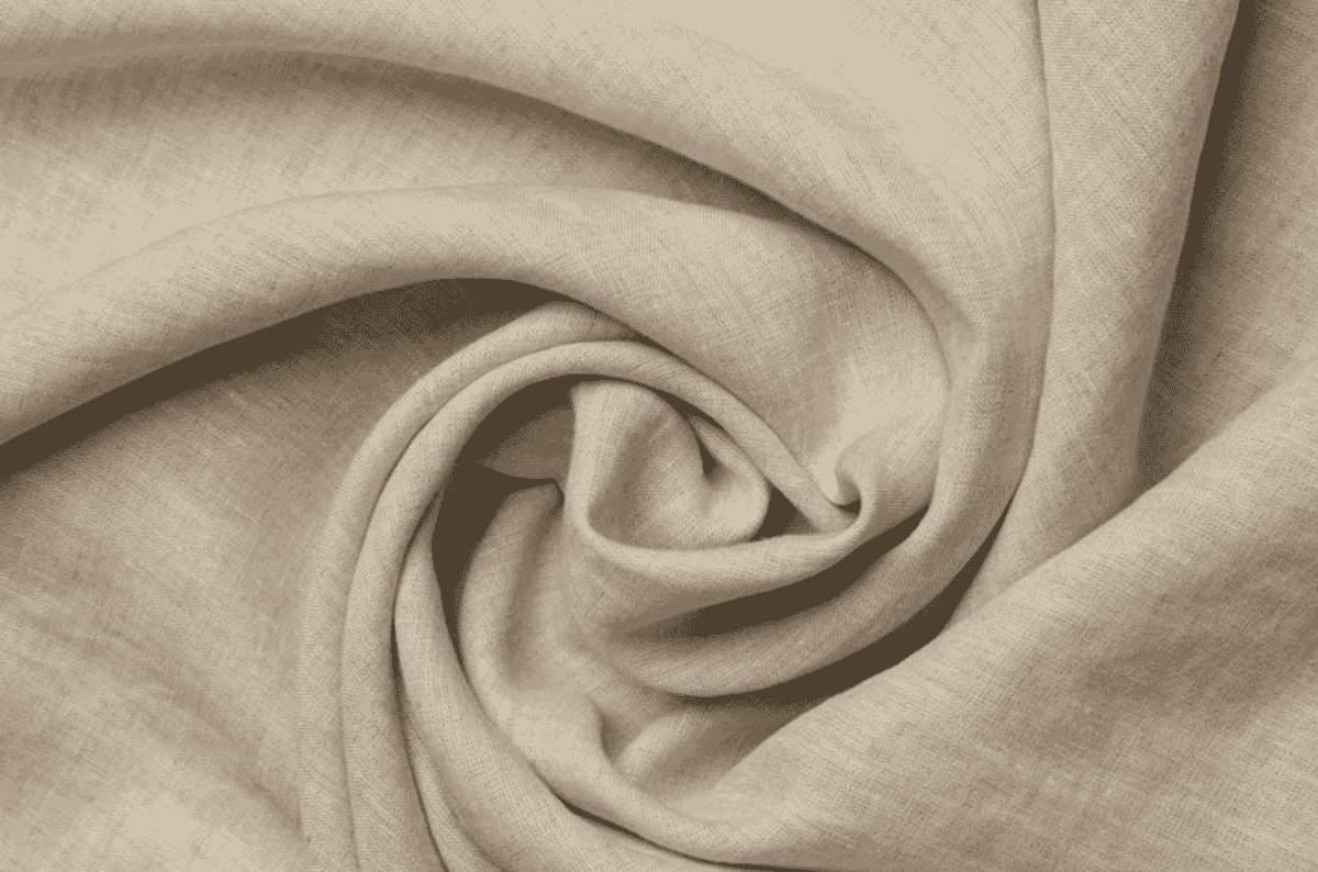 A length of natural undyed linen swirled flat, showing the open plain weave and the slubby, irregular yarn typical of flax.