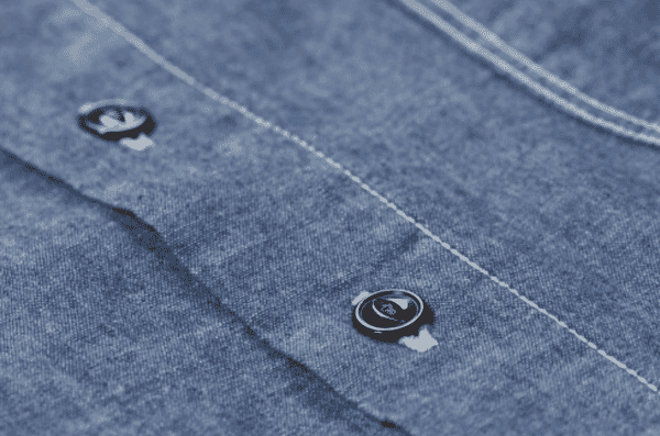 Buttons on a chambray shirt placket