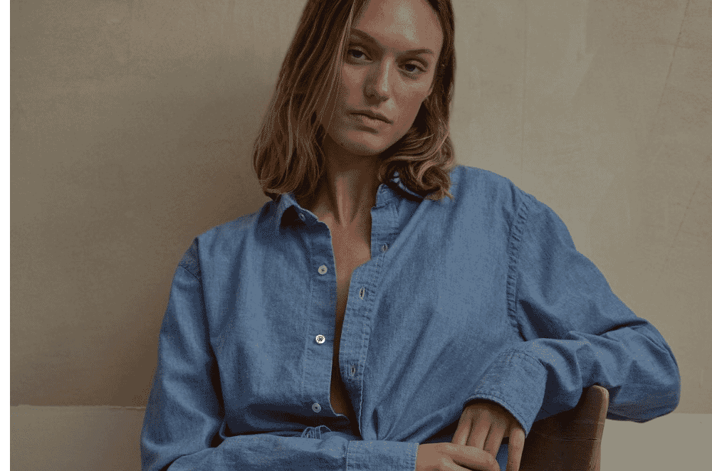 Heavyweight indigo denim fabric with a visible diagonal twill wale, showing the stiff durable hand typical of jeans and jackets.