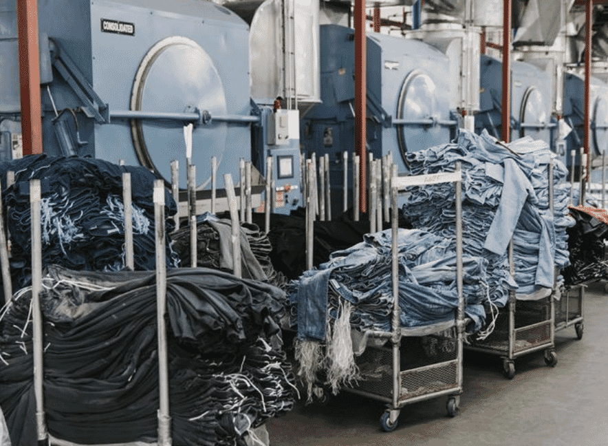 Enzyme-washed denim showing a soft, uniform fade produced through cellulase biochemistry rather than mechanical abrasion.