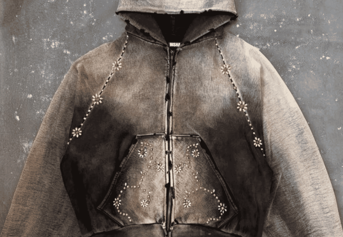 A distressed heavyweight zip hoodie photographed flat, showing the dense, stiff hand of fabric in the 550 GSM and above band.