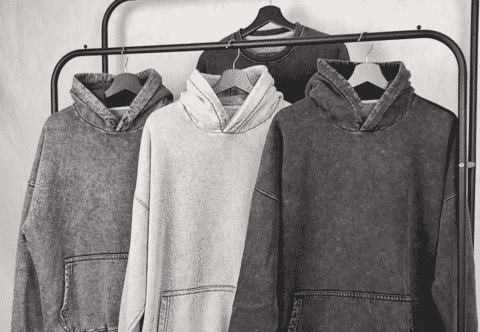 Three washed hoodies hanging on a rail