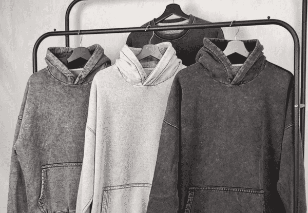 Three washed hoodies hanging on a rail