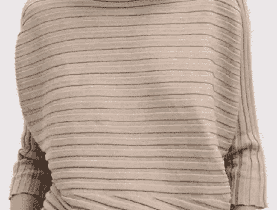 Close-up of a ribbed cotton knit top folded on a wooden surface, showing the vertical wale structure and slightly contracted width typical of finished rib fabric.
