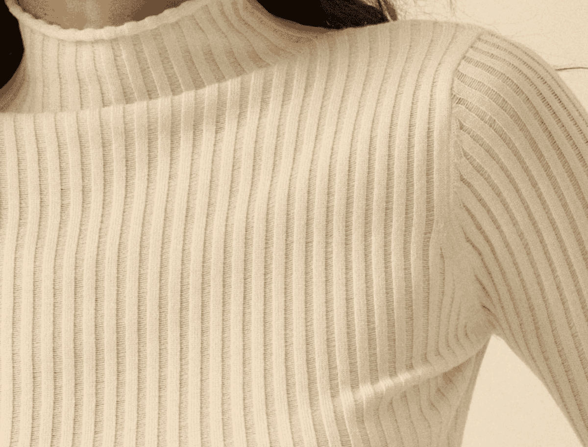 Drop-needle rib knit fabric showing widened, textural columns produced by skipped needles in the knitting sequence.