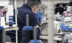 Operator sewing on an industrial machine
