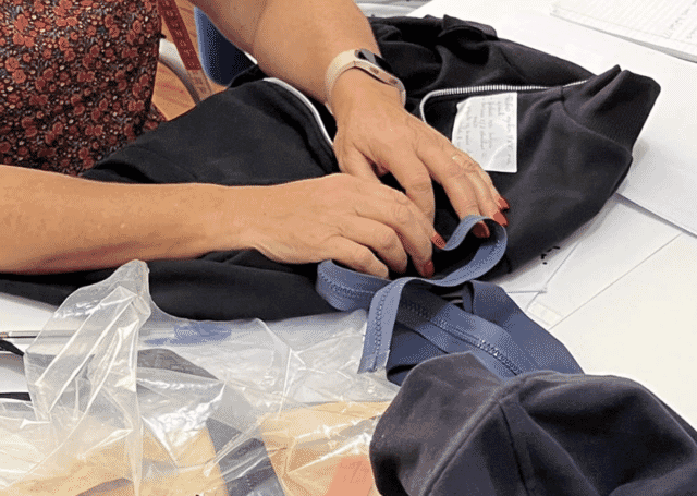 Finishing a zip hoodie in a garment factory