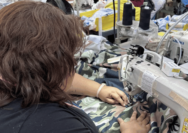 Sewing a camo-print garment in a garment factory